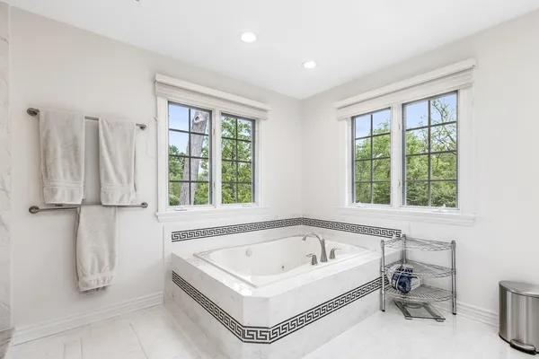 a spacious bathroom with a double sink shower and a mirror