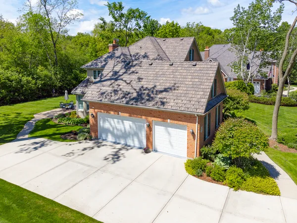 a view of a house with a yard patio and fire pit