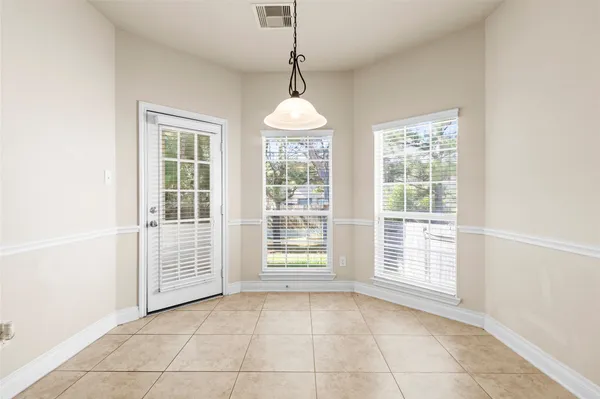 an empty room with windows and entryway