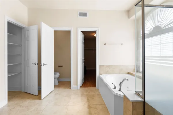 a spacious bathroom with a granite countertop sink and a mirror