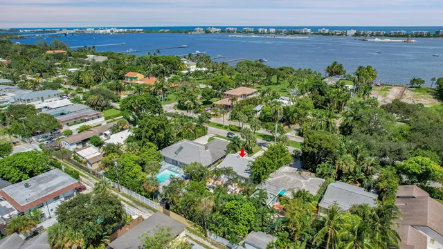 an aerial view of a house with a yard and lake view