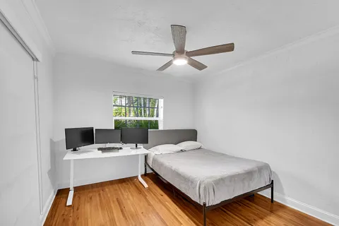 a bedroom with a bed and glass window