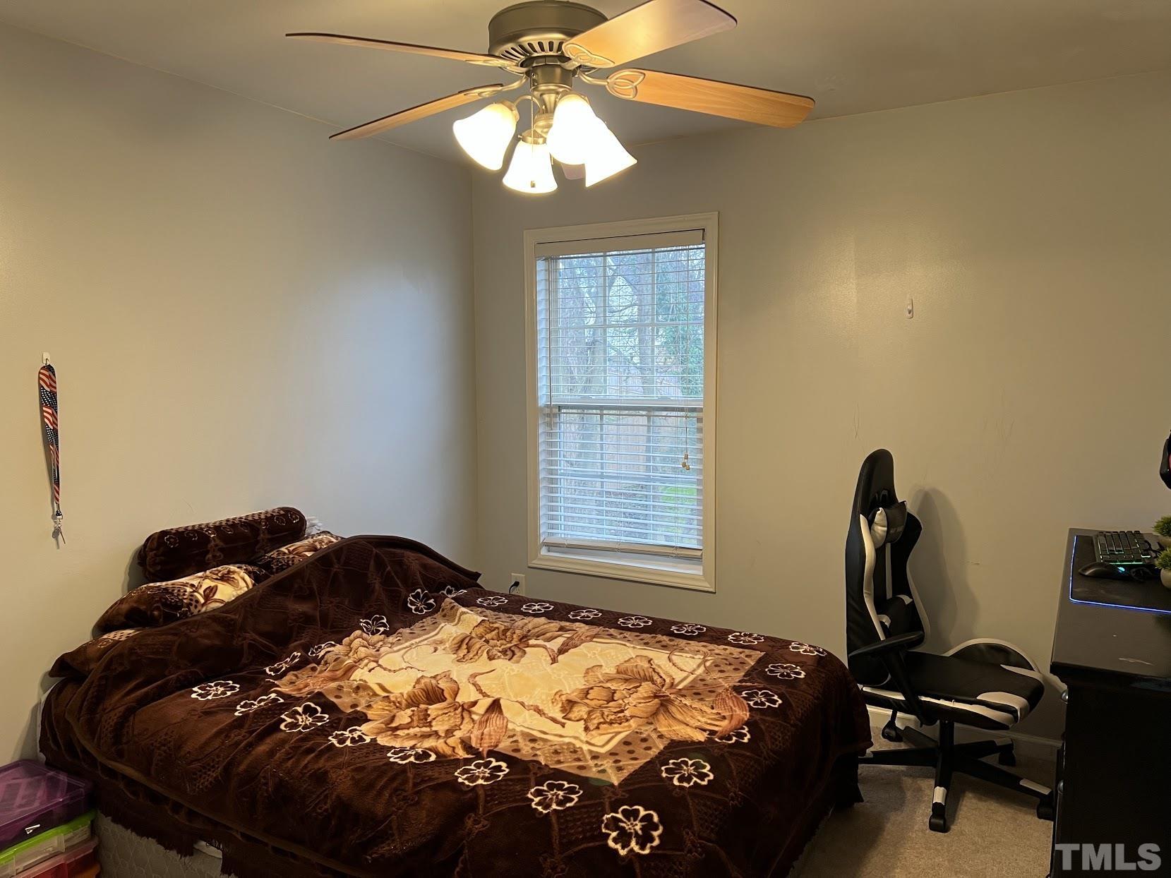 4109 Bay Rum Lane Raleigh, NC 27610 - Photo 11 of 31 a bed sitting in a bedroom next to a window