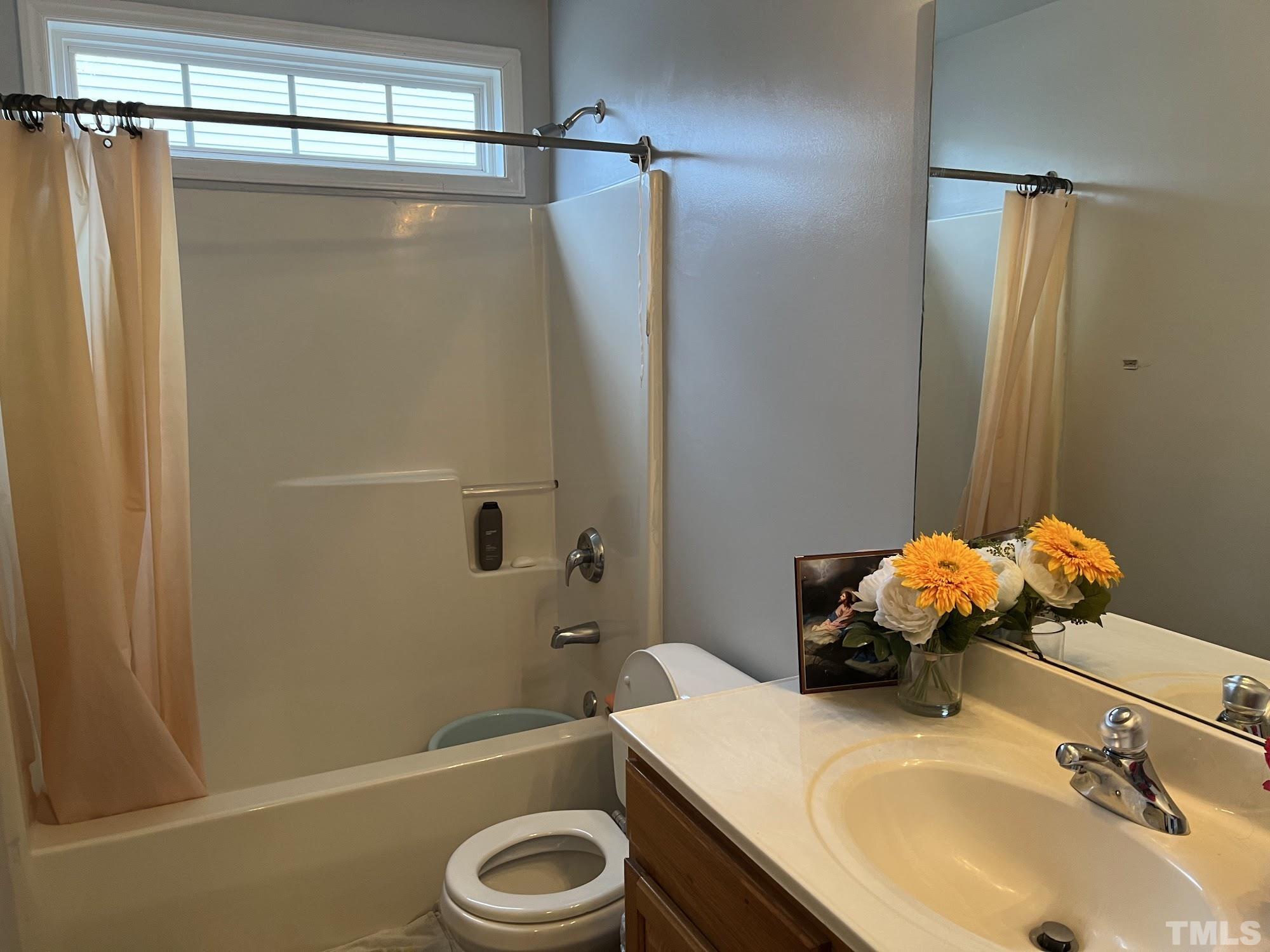 4109 Bay Rum Lane Raleigh, NC 27610 - Photo 13 of 31 a bathroom with a sink a toilet and shower
