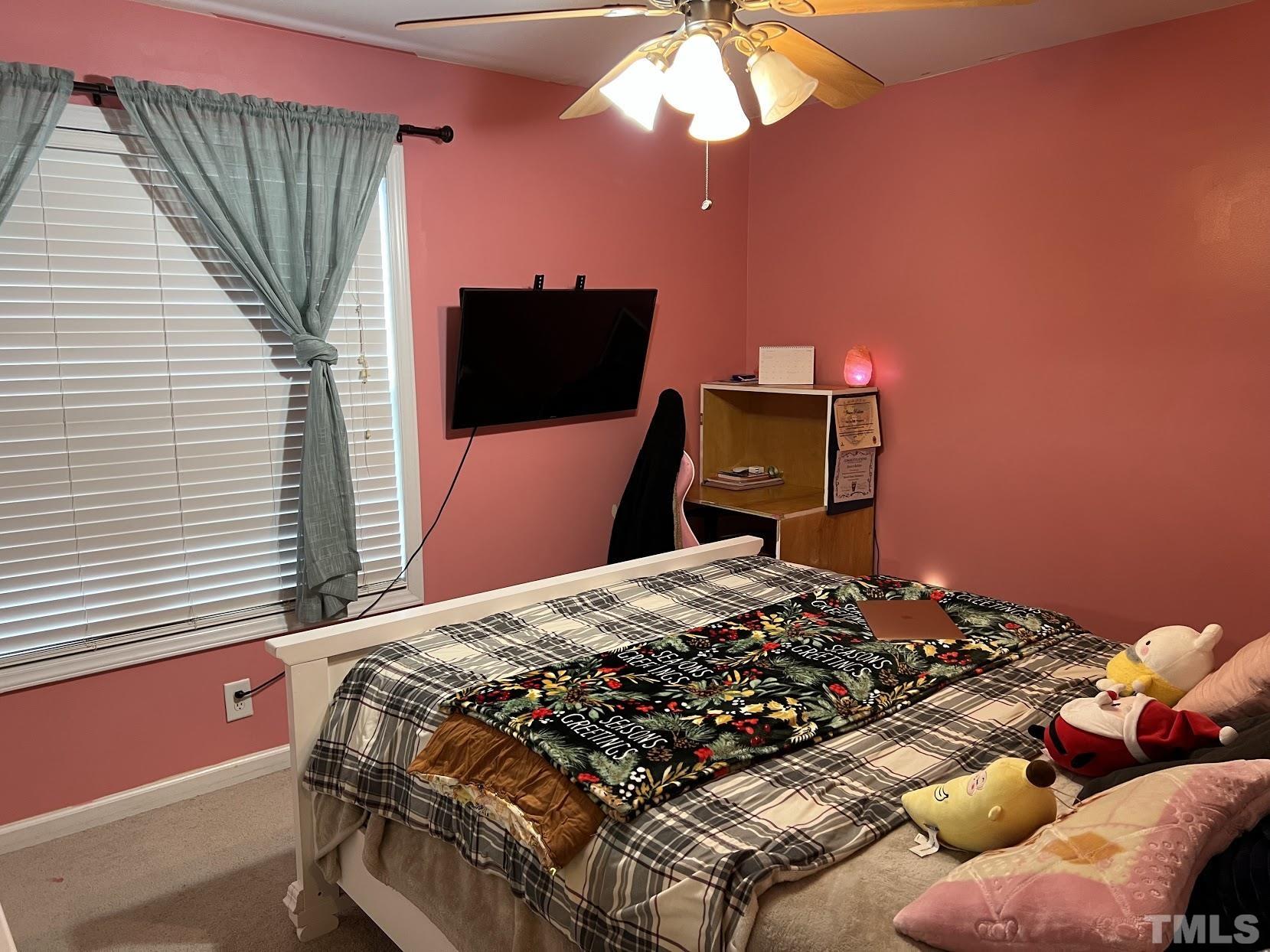 4109 Bay Rum Lane Raleigh, NC 27610 - Photo 14 of 31 a bedroom with a bed and a television