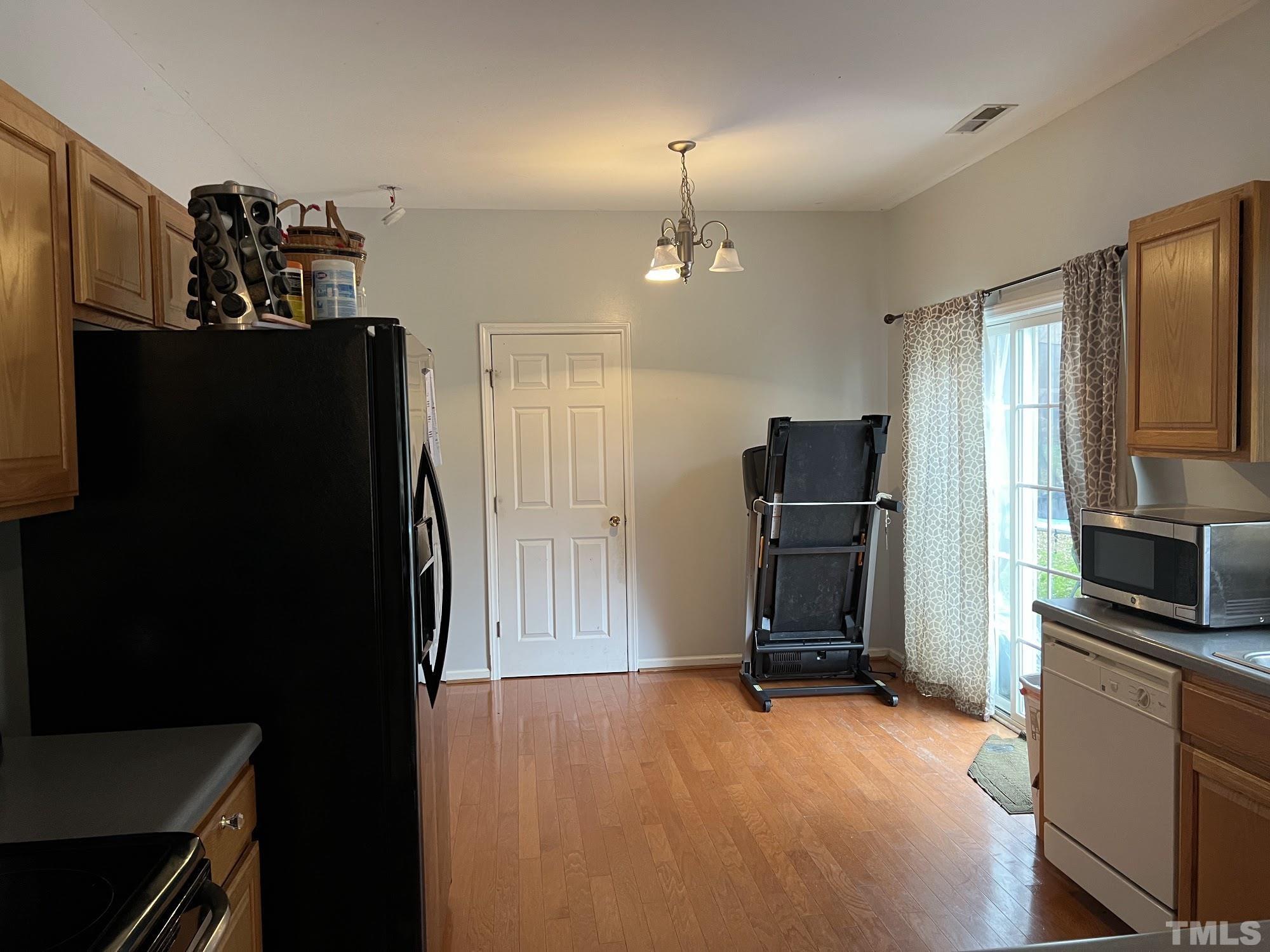 4109 Bay Rum Lane Raleigh, NC 27610 - Photo 16 of 31 a view of a kitchen with refrigerator and chair