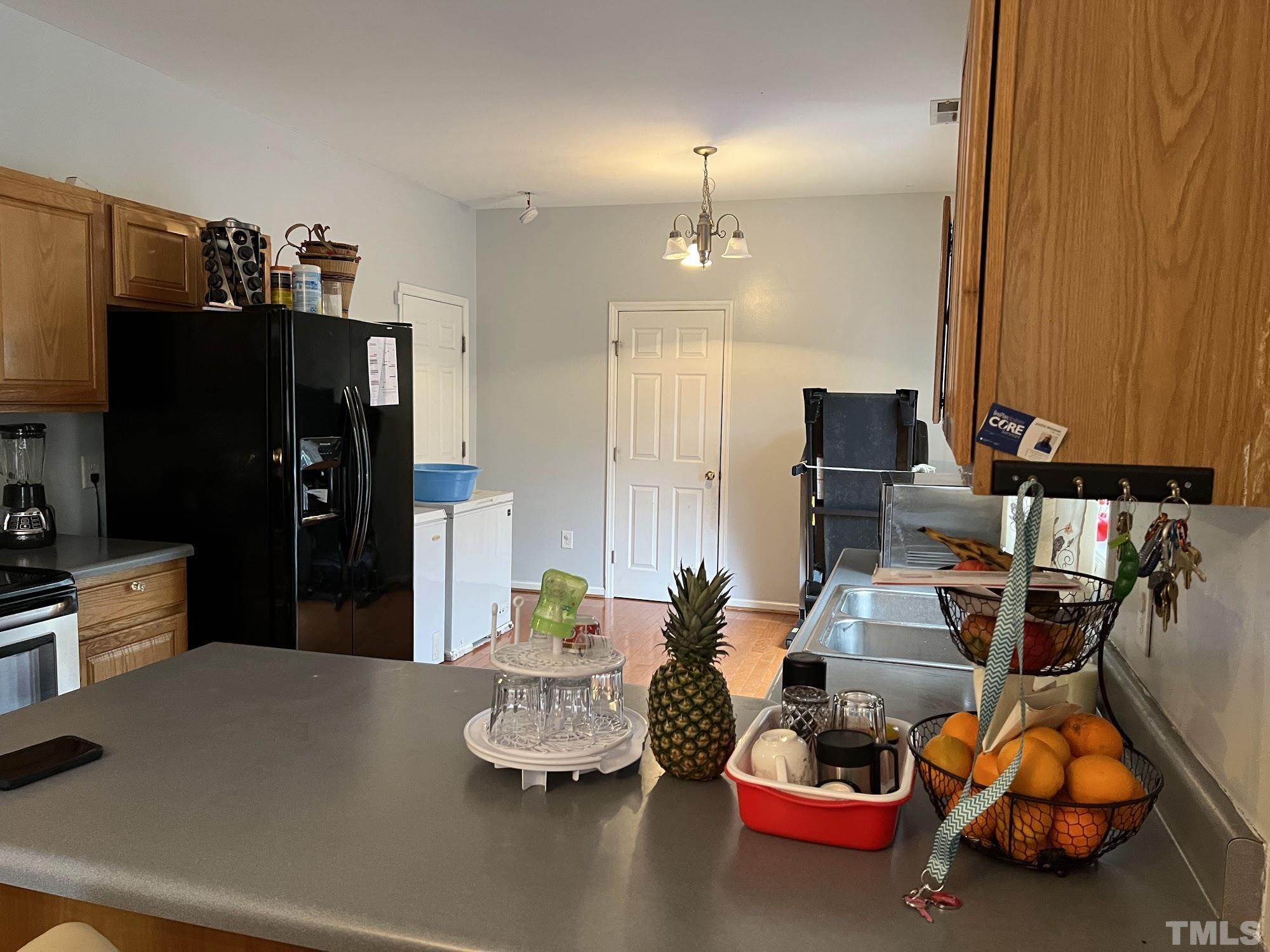 4109 Bay Rum Lane Raleigh, NC 27610 - Photo 19 of 31 a room with lots of gym equipment and refrigerator