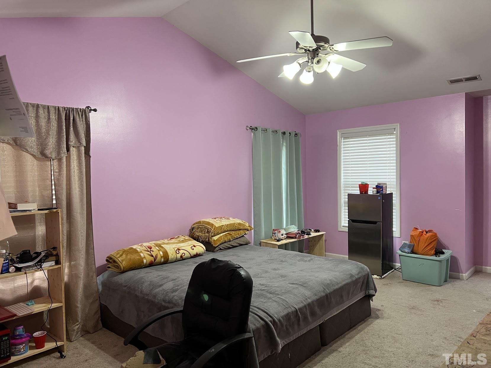 4109 Bay Rum Lane Raleigh, NC 27610 - Photo 2 of 31 a bedroom with a bed and a chandelier