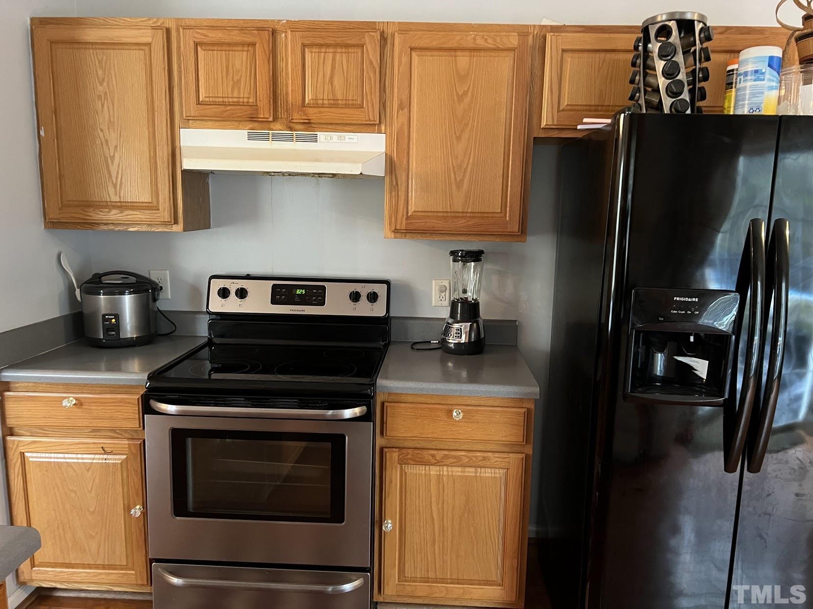 4109 Bay Rum Lane Raleigh, NC 27610 - Photo 21 of 31 a kitchen with stainless steel appliances granite countertop a stove and a refrigerator