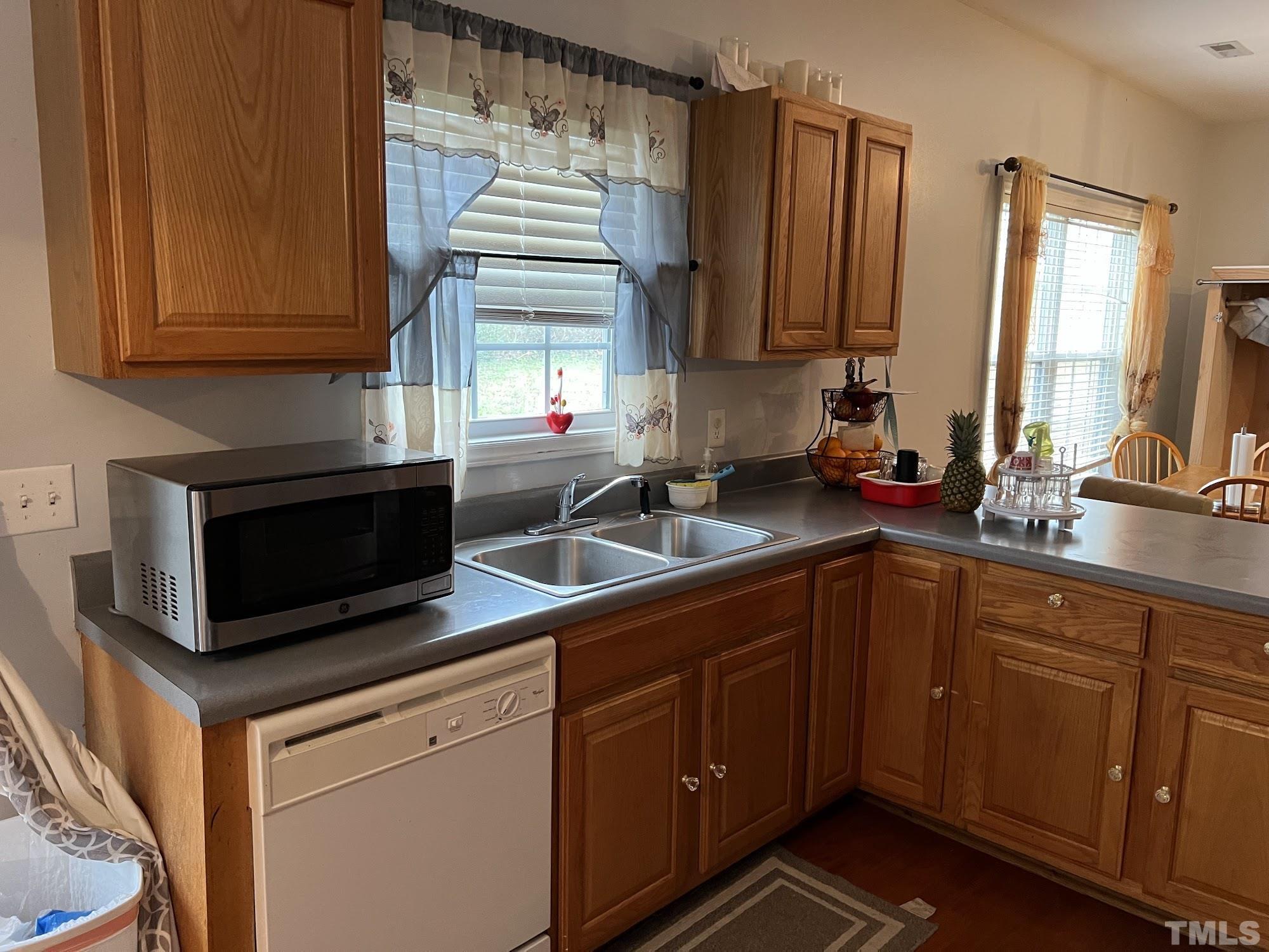 4109 Bay Rum Lane Raleigh, NC 27610 - Photo 22 of 31 a kitchen with stainless steel appliances a stove a sink and a microwave