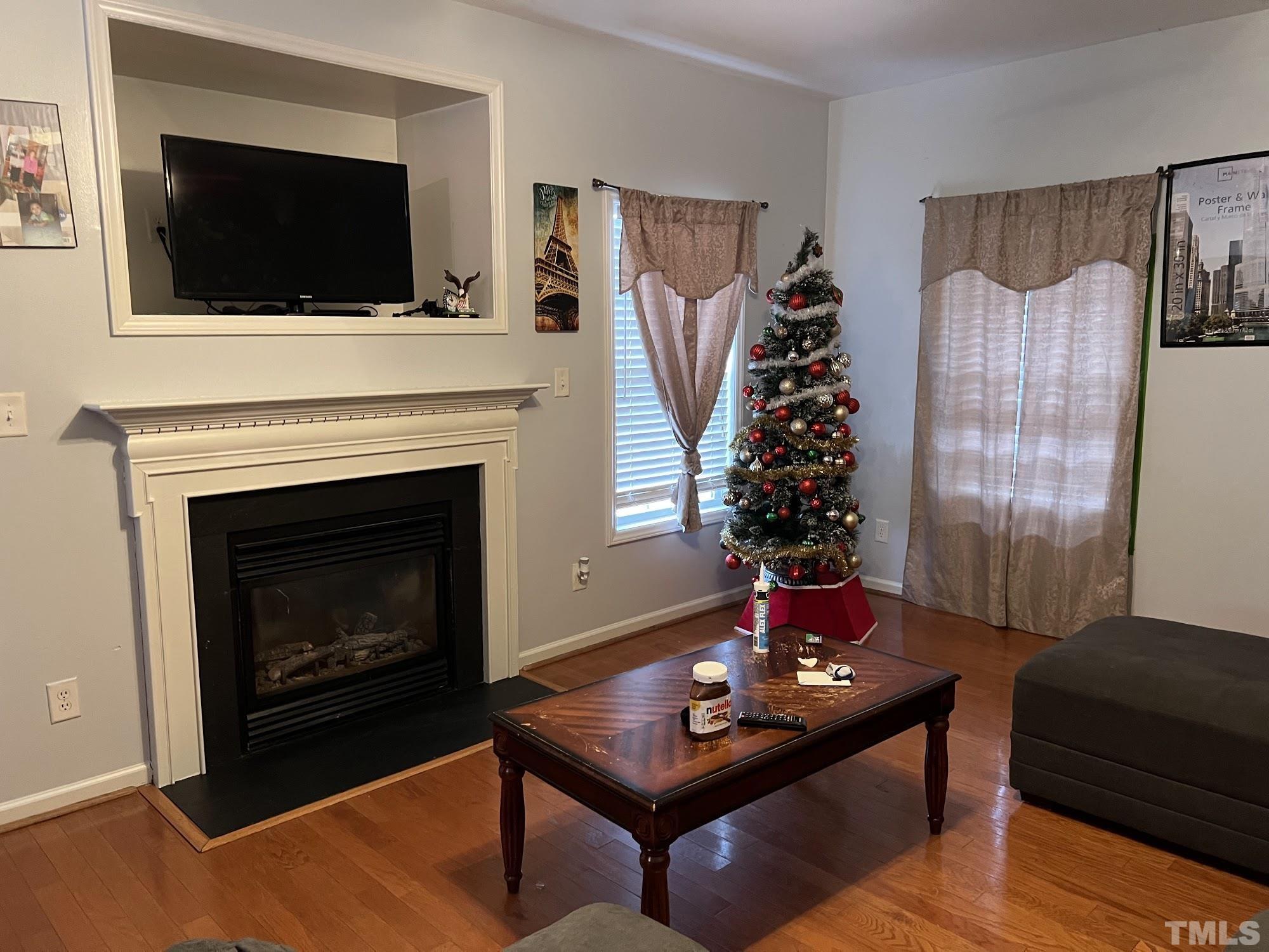 4109 Bay Rum Lane Raleigh, NC 27610 - Photo 27 of 31 a living room with furniture fireplace and flat screen tv