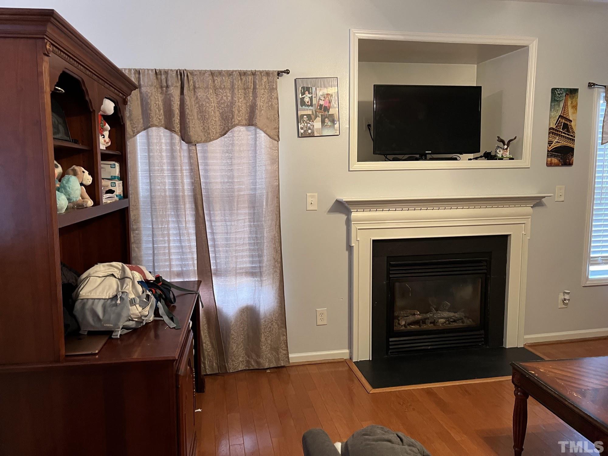 4109 Bay Rum Lane Raleigh, NC 27610 - Photo 28 of 31 a living room with furniture and a flat screen tv