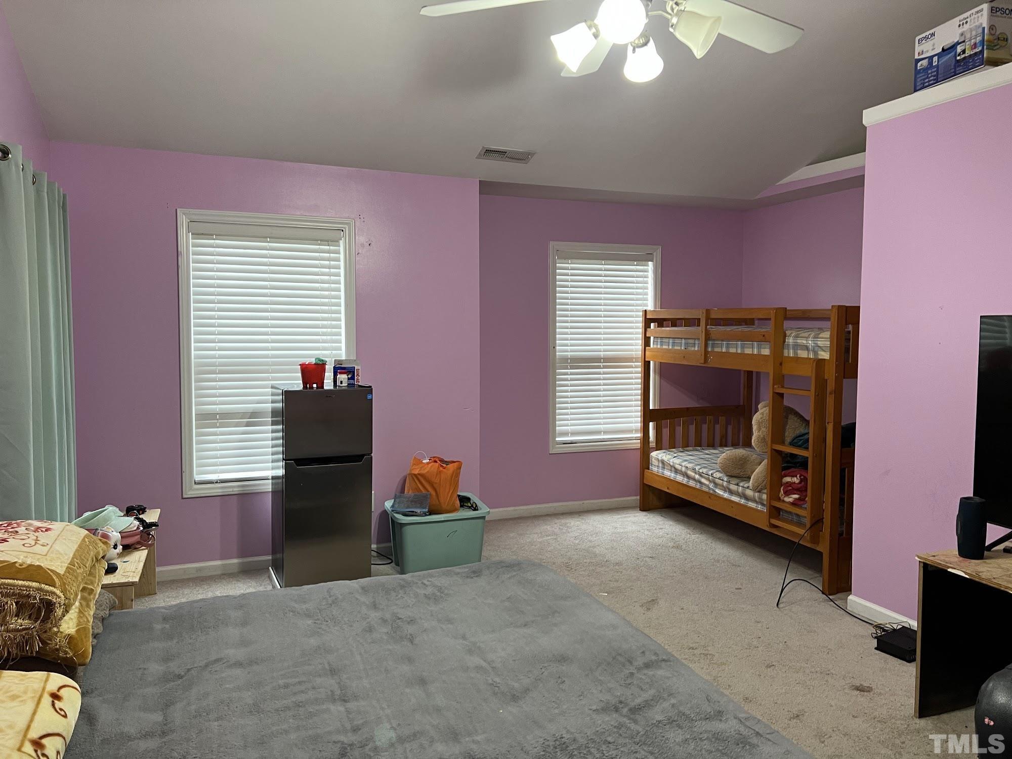 4109 Bay Rum Lane Raleigh, NC 27610 - Photo 4 of 31 a view of a room with gym equipment and windows