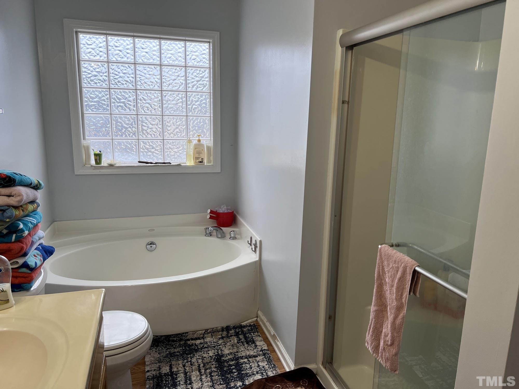 4109 Bay Rum Lane Raleigh, NC 27610 - Photo 8 of 31 a white bath tub sitting next to a toilet