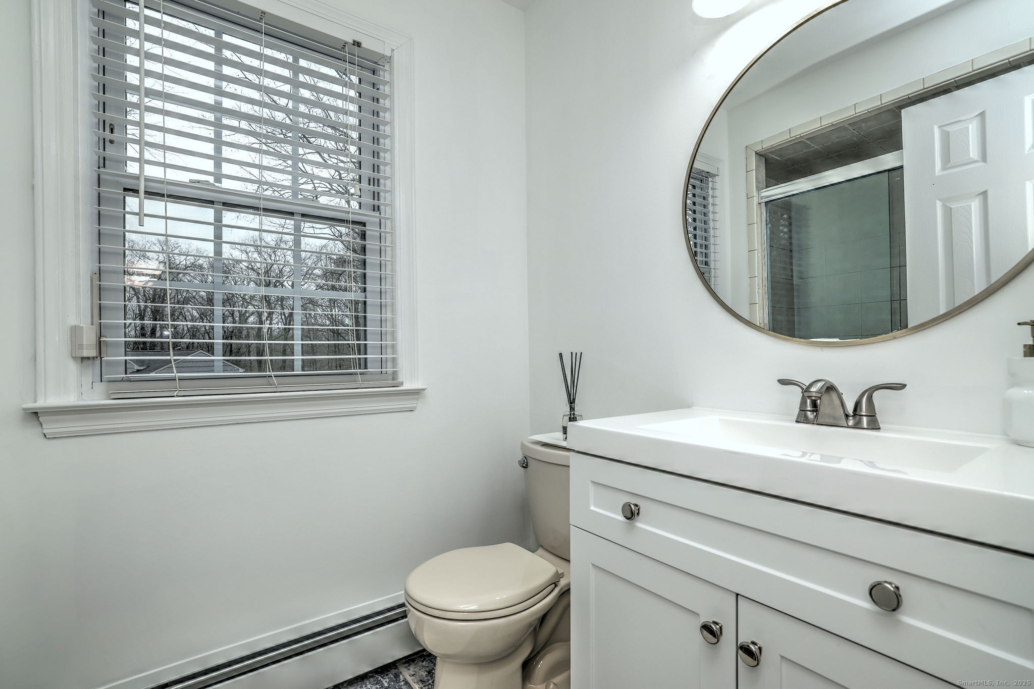 119 Wedgemere Road Stamford, CT 06905 - Photo 24 of 40 a bathroom with a toilet sink and mirror