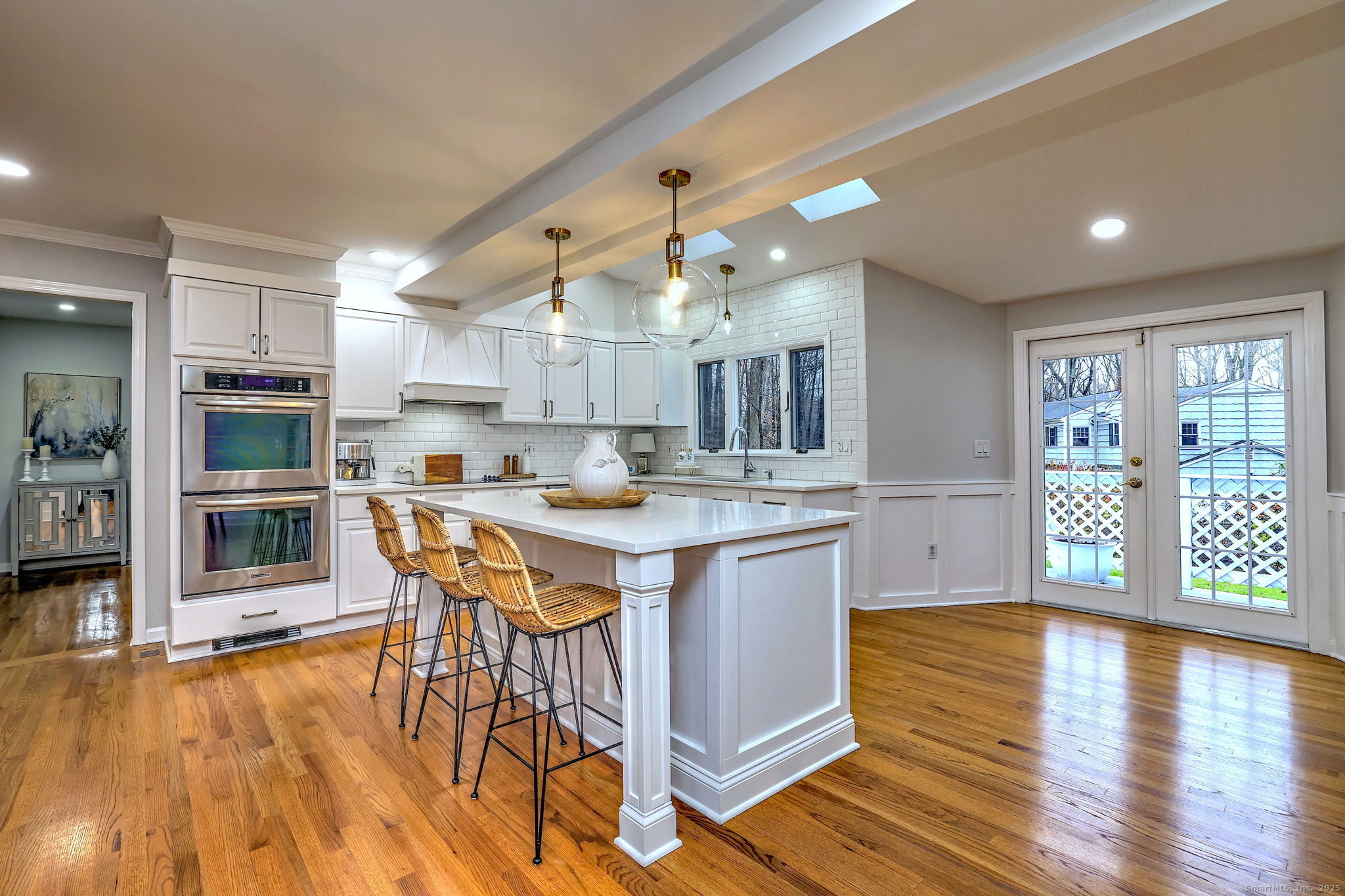 119 Wedgemere Road Stamford, CT 06905 - Photo 4 of 40 a open kitchen with stainless steel appliances granite countertop a stove top oven a dining table and chairs with wooden floor