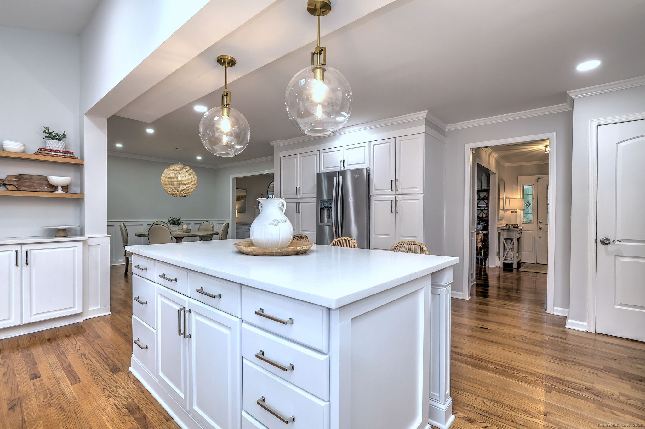 119 Wedgemere Road Stamford, CT 06905 - Photo 6 of 40 a kitchen with a sink dishwasher and a dining table with wooden floor