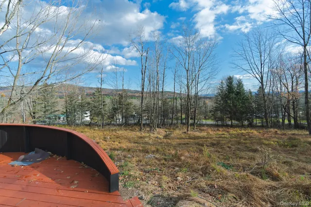 an aerial view of a house with swimming pool and outdoor seating