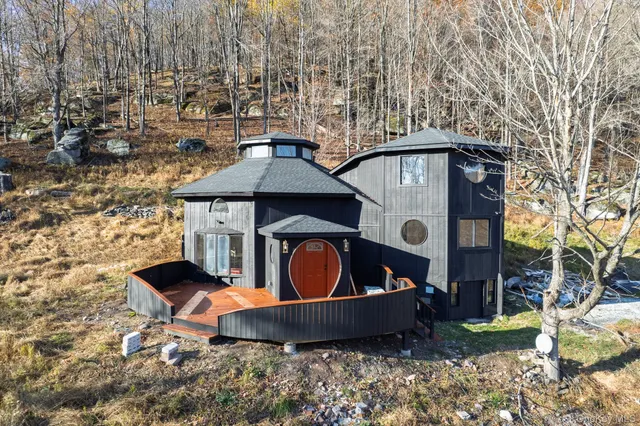 a front view of a house with garden and patio