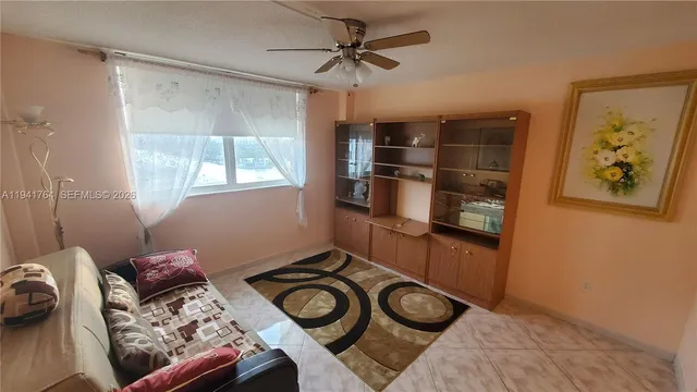 a view of a livingroom with furniture and a fan