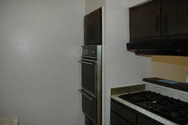 a kitchen with a stove and a refrigerator