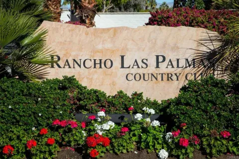 a sign that is in front of flowers