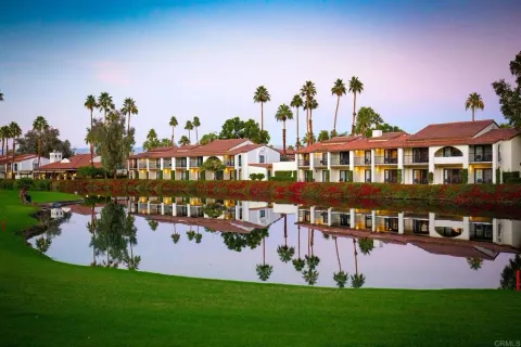 a swimming pool with outdoor seating and garden