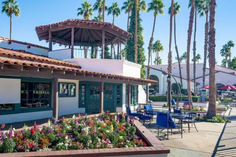 a view of a house with a patio and a garden