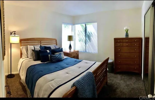 a bed sitting in a bedroom next to a window