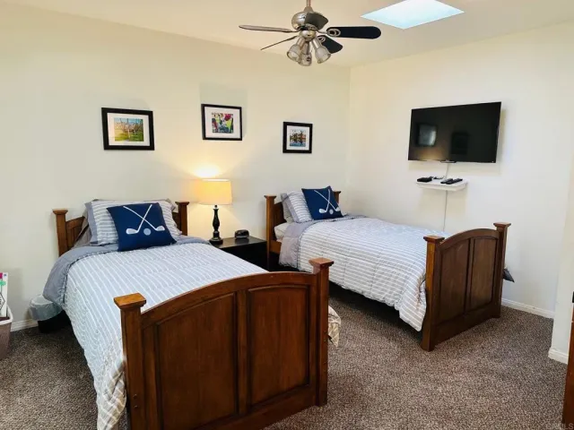 a bedroom with a bed and a flat screen tv