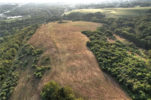 an aerial view of ocean with residential house and space