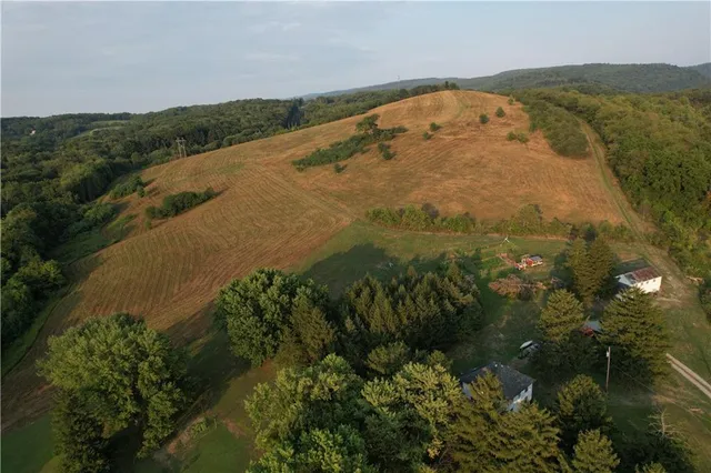 an aerial view of a house with a yard