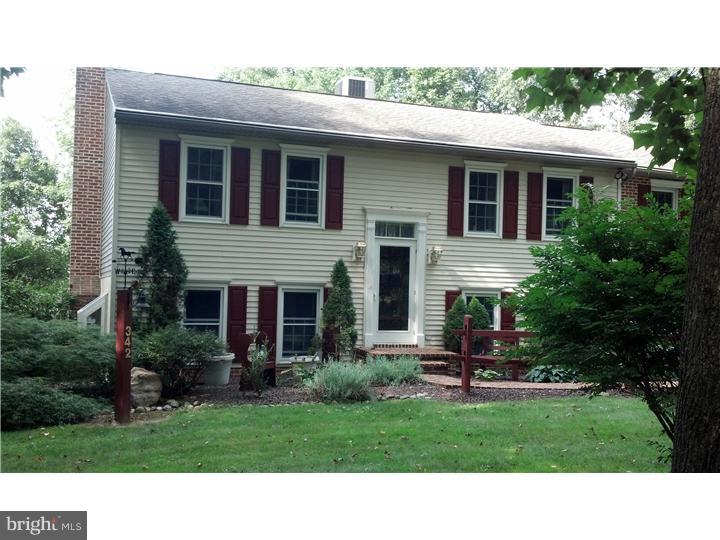 342 Pine Grove Road Nottingham, PA 19362 - Photo 2 of 19 a black and white house with a yard plants and large tree