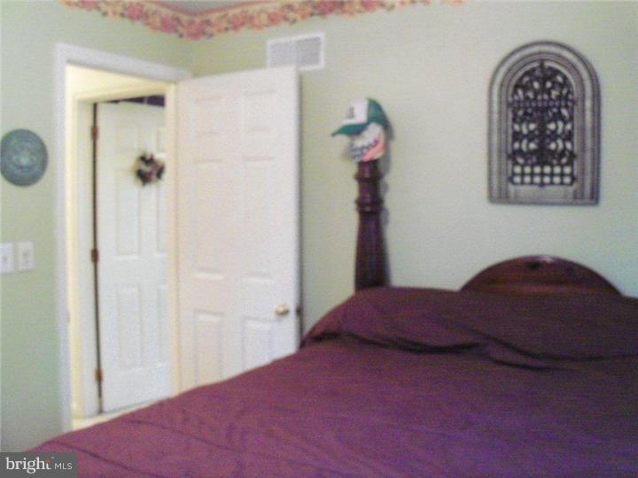342 Pine Grove Road Nottingham, PA 19362 - Photo 11 of 19 a bedroom with a bed and a chandelier