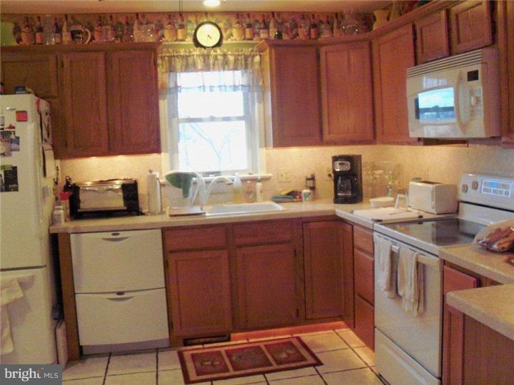 342 Pine Grove Road Nottingham, PA 19362 - Photo 10 of 19 a kitchen with a sink cabinets and window
