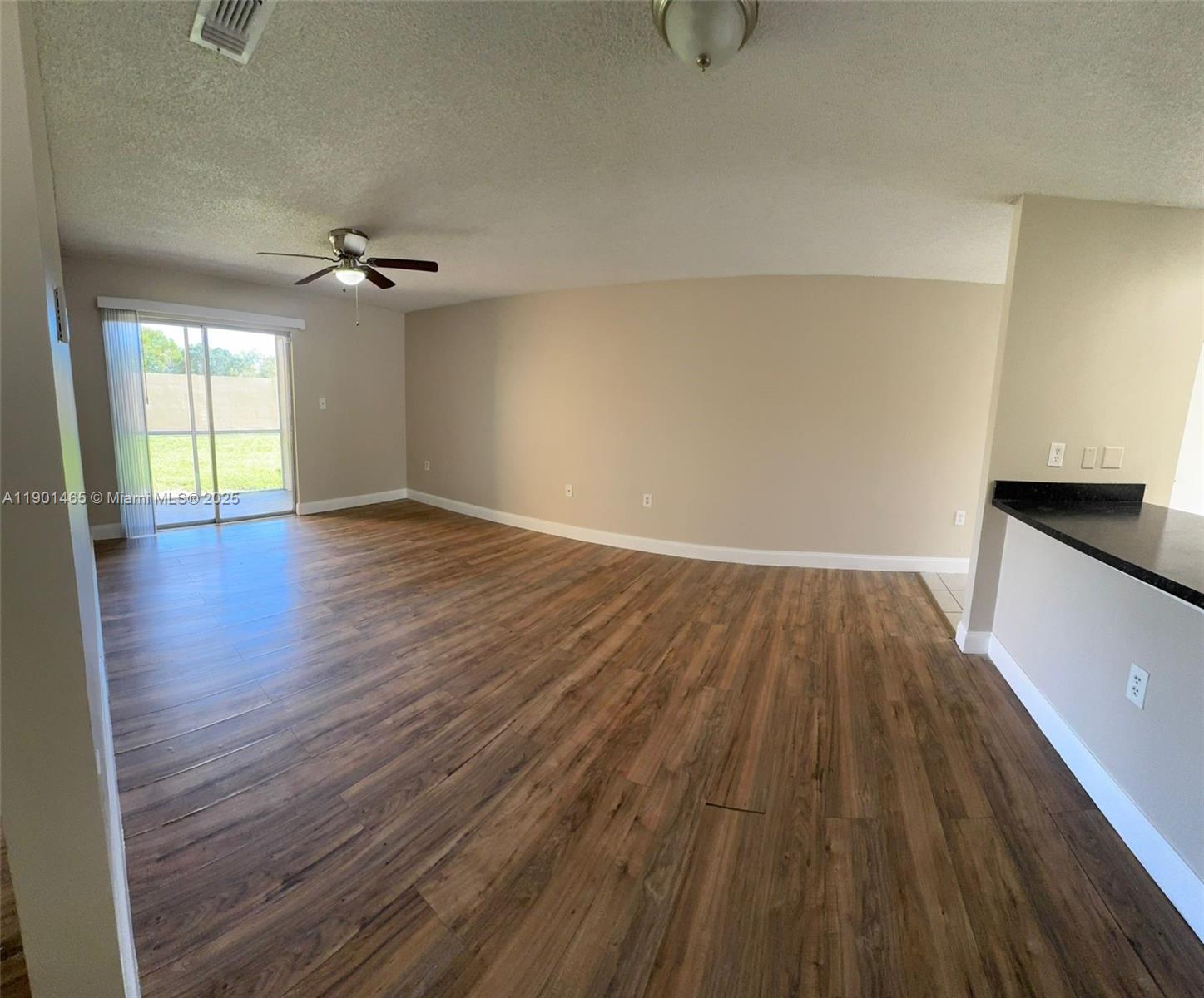 2173 Southwest 80th Terrace, Unit 2173 Miramar, FL 33025 - Photo 11 of 31 a view of empty room with wooden floor and fan