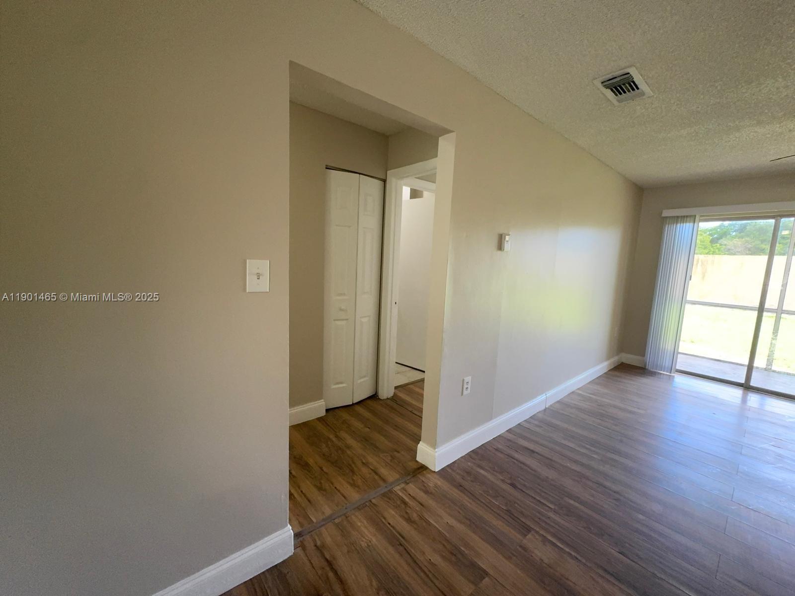 2173 Southwest 80th Terrace, Unit 2173 Miramar, FL 33025 - Photo 12 of 31 an empty room with wooden floor and windows