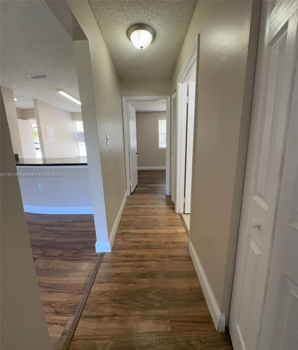 2173 Southwest 80th Terrace, Unit 2173 Miramar, FL 33025 - Photo 13 of 31 a view of a hallway with wooden floor and staircase