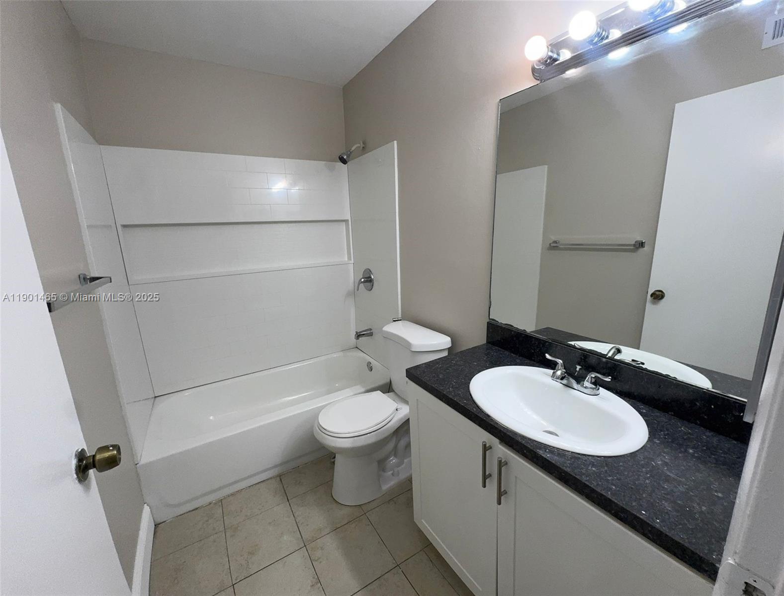 2173 Southwest 80th Terrace, Unit 2173 Miramar, FL 33025 - Photo 15 of 31 a bathroom with a granite countertop sink toilet mirror and a bathtub