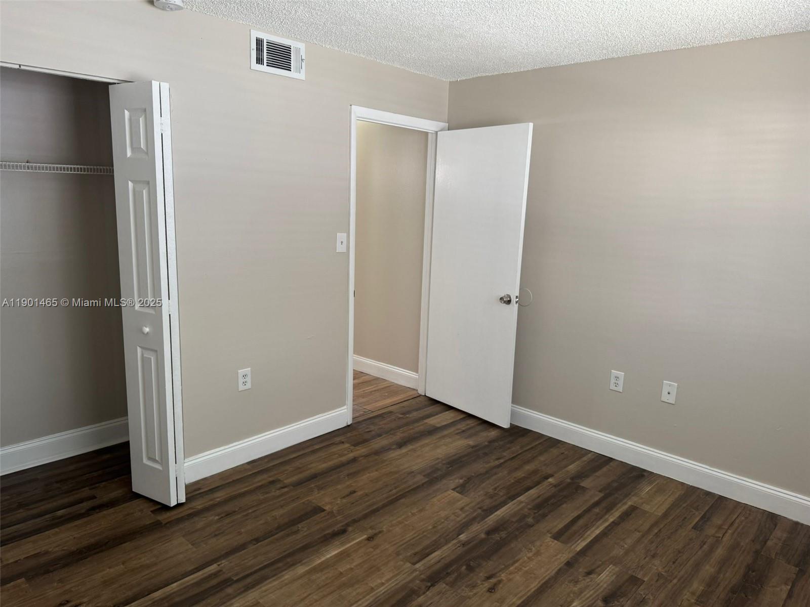 2173 Southwest 80th Terrace, Unit 2173 Miramar, FL 33025 - Photo 17 of 31 a view of an empty room with wooden floor and closet