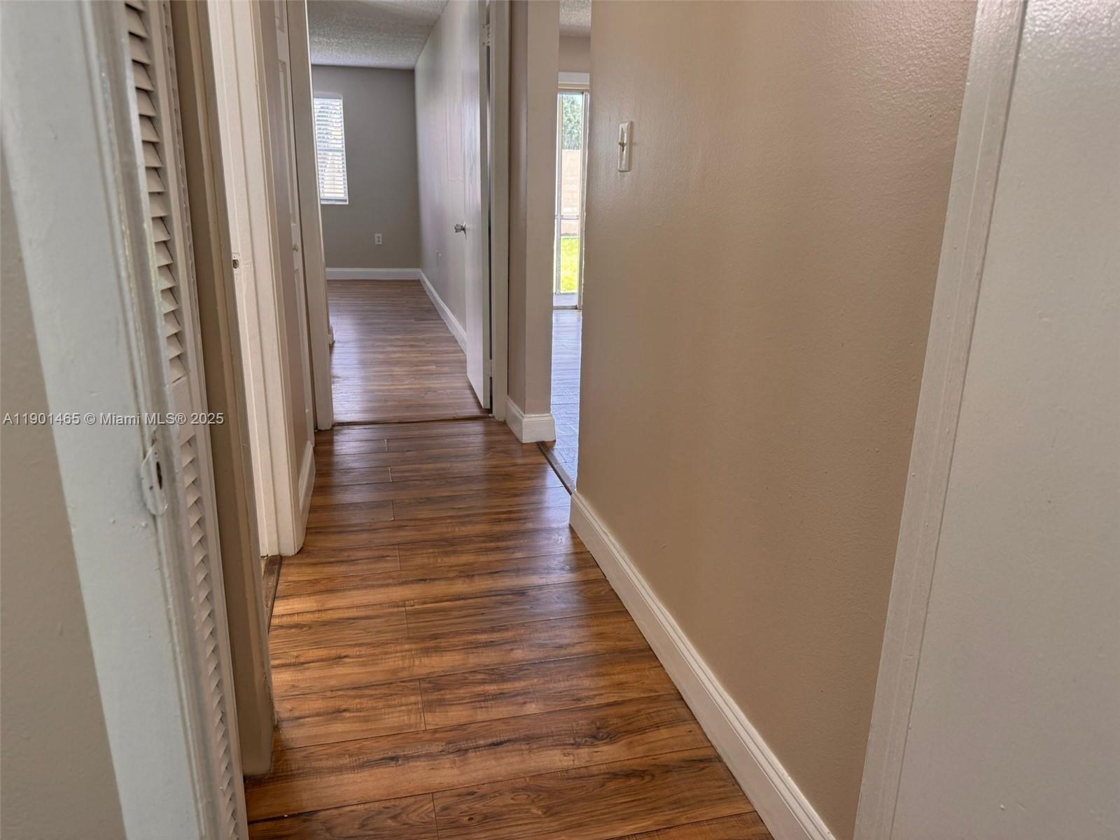 2173 Southwest 80th Terrace, Unit 2173 Miramar, FL 33025 - Photo 19 of 31 a view of a hallway with wooden floor