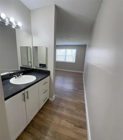 a spacious bathroom with a double vanity sink and a mirror