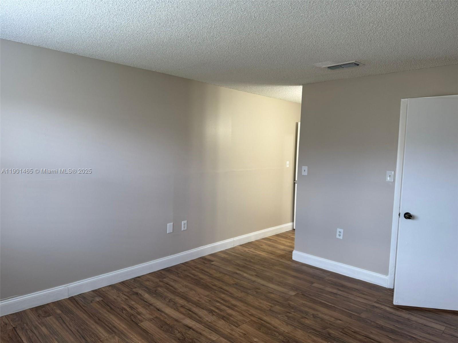 2173 Southwest 80th Terrace, Unit 2173 Miramar, FL 33025 - Photo 26 of 31 a view of an empty room with wooden floor