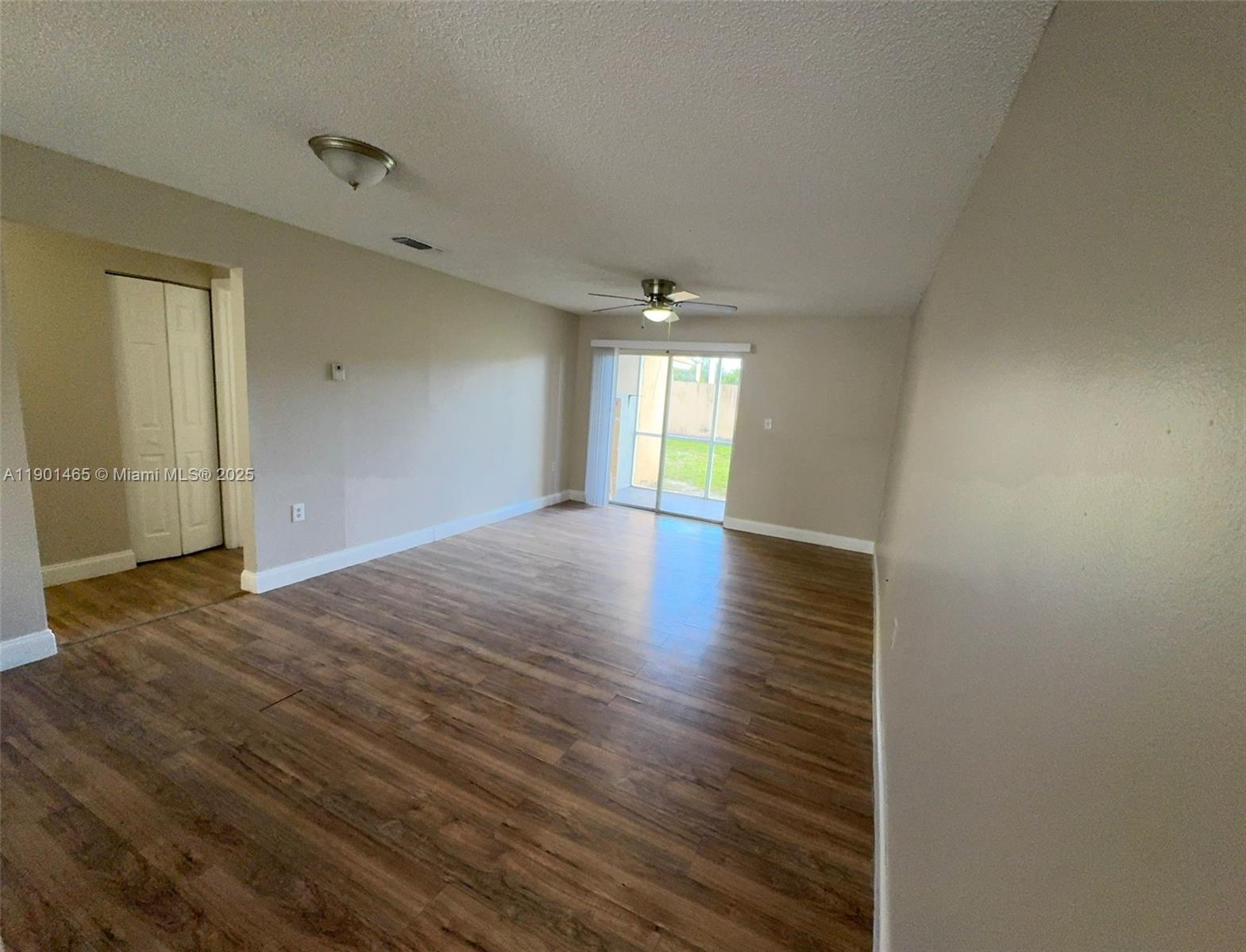 2173 Southwest 80th Terrace, Unit 2173 Miramar, FL 33025 - Photo 9 of 31 wooden floor in an empty room with a window