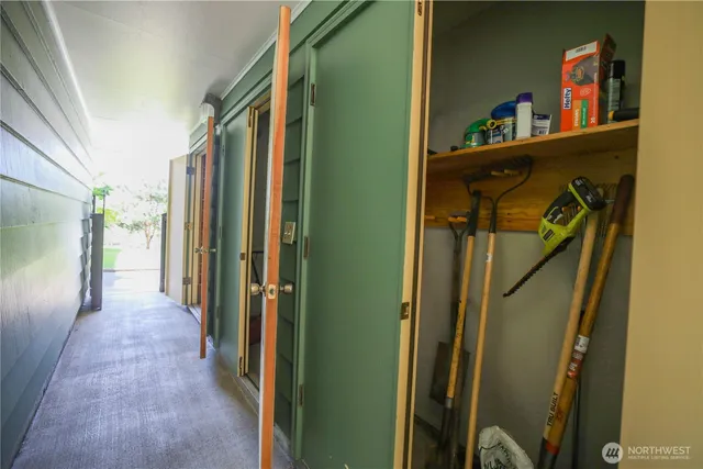 a view of a hallway with closet and wooden floor
