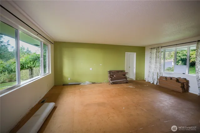 a view of a big room with furniture and floor to ceiling window
