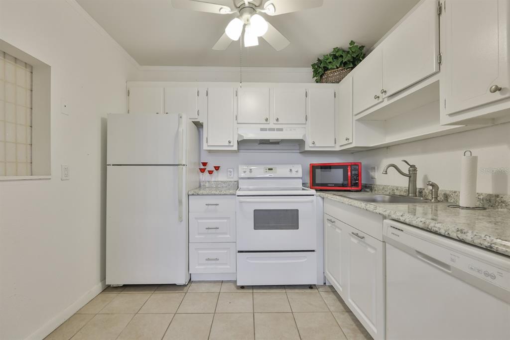 1901 Andover Way, Unit 38 Sun City Center, FL 33573 - Photo 12 of 54 a kitchen with cabinets stainless steel appliances and a counter space