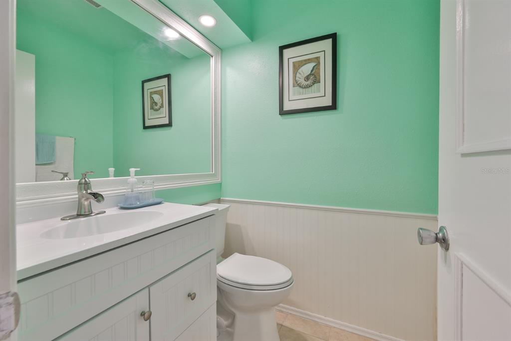 1901 Andover Way, Unit 38 Sun City Center, FL 33573 - Photo 15 of 54 a bathroom with a sink mirror and toilet