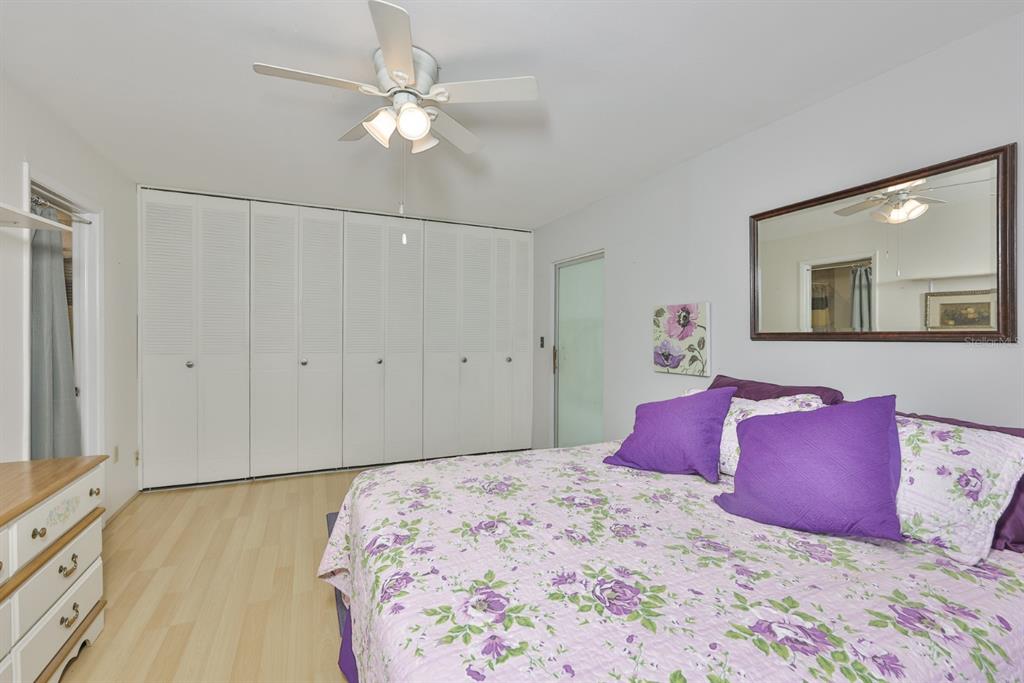1901 Andover Way, Unit 38 Sun City Center, FL 33573 - Photo 17 of 54 a bedroom with a large bed and a chandelier
