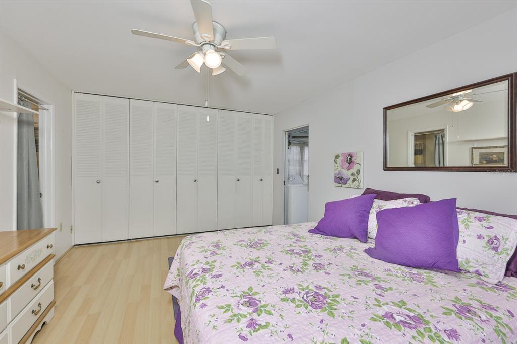 1901 Andover Way, Unit 38 Sun City Center, FL 33573 - Photo 18 of 54 a bedroom with a large bed and a chandelier